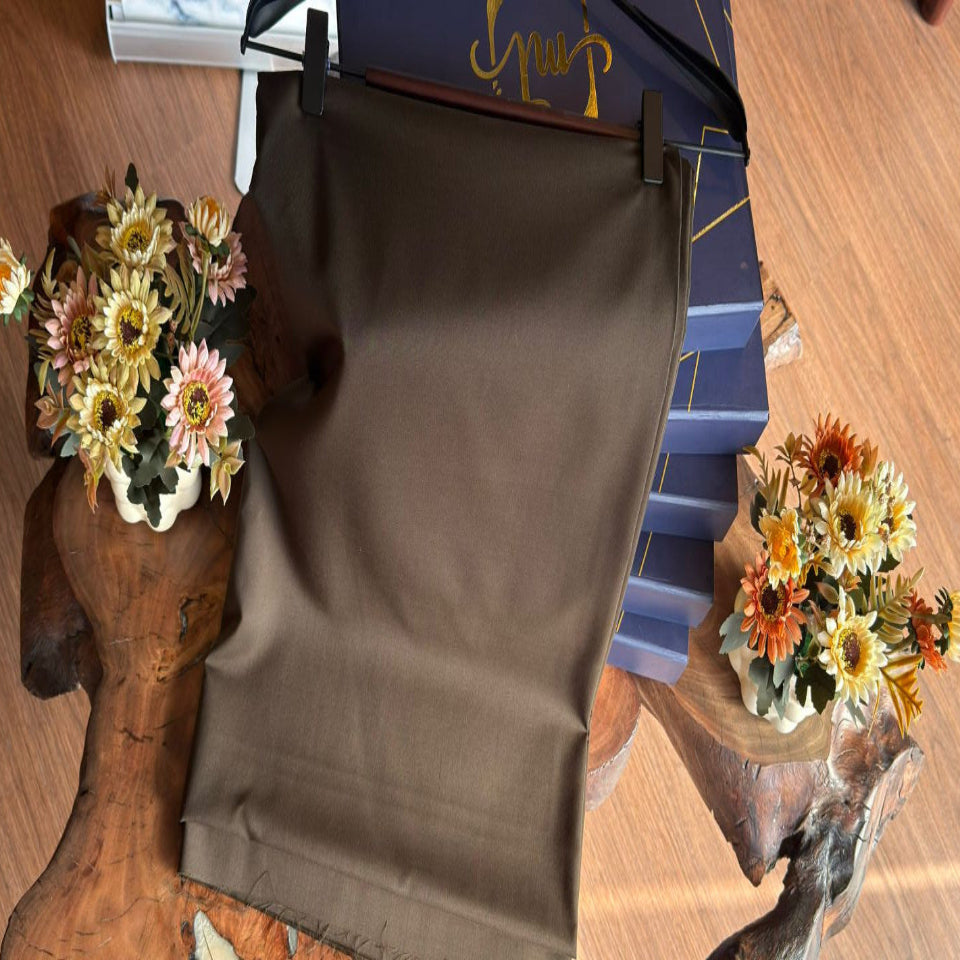 Brown bag on a wooden surface with decorative flowers and a box in the background