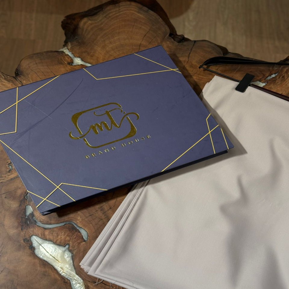 Blue box with gold logo on a wooden surface