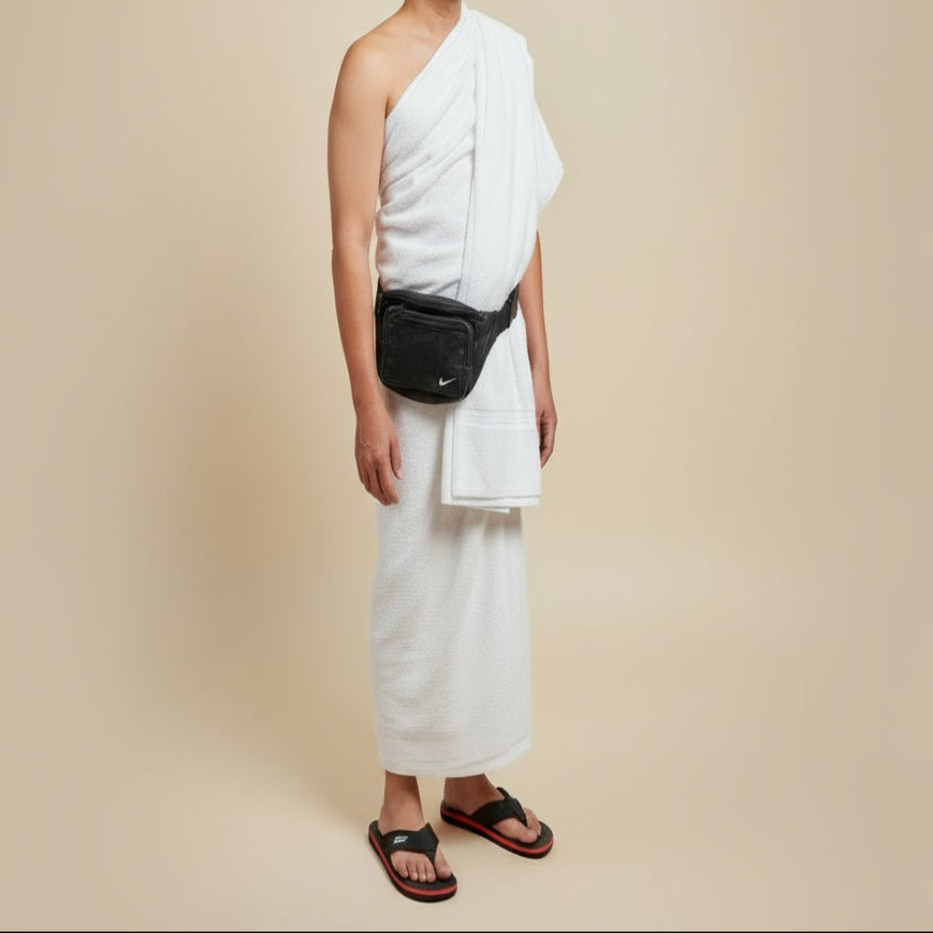 Two yellow bags with white towels inside, a black bag, and sandals on a wooden surface.