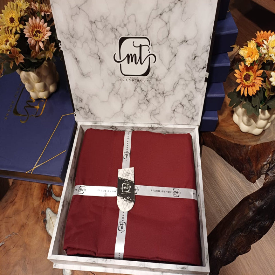 Red fabric in a marble-patterned box with 'fmt' branding, surrounded by decorative items.