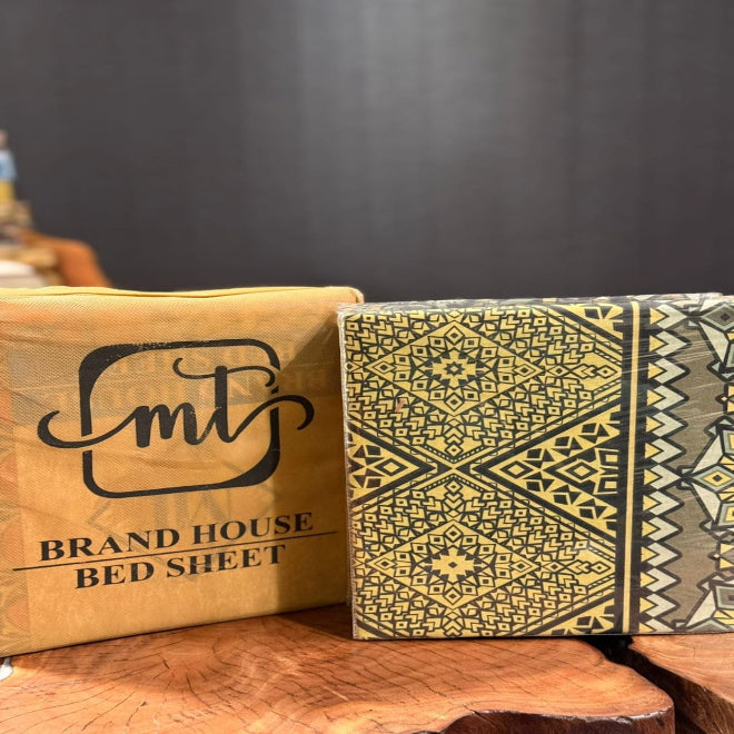 Packaged bed sheets with a brand logo on a wooden surface